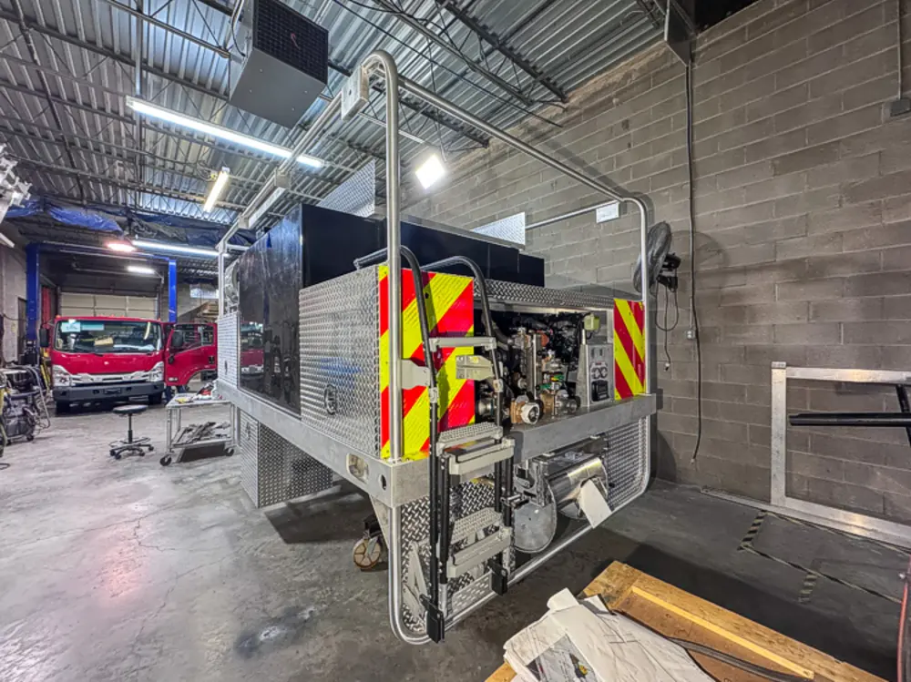 Diamond-plate body and step detail in production, photo 108 of 303.